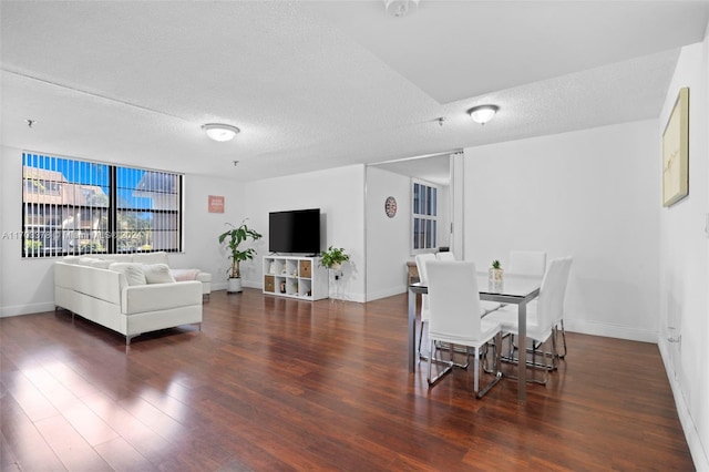 dining room featuring a textured ceiling and dark wood-type flooring