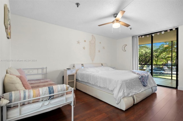 bedroom featuring access to outside, a textured ceiling, dark hardwood / wood-style floors, and ceiling fan