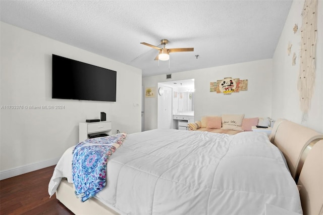 bedroom with a textured ceiling, ceiling fan, dark hardwood / wood-style floors, and ensuite bathroom