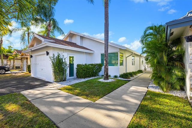 view of side of home with a lawn and a garage