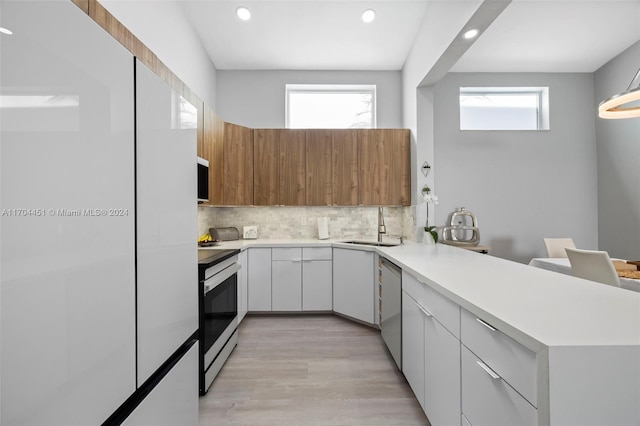 kitchen featuring white cabinets, appliances with stainless steel finishes, and a wealth of natural light