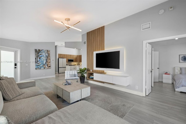 living room with a chandelier and hardwood / wood-style floors