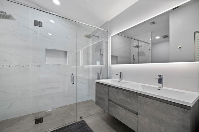 bathroom featuring tile patterned floors, a shower with door, and vanity