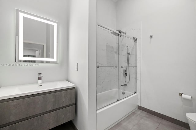 full bathroom with tile patterned flooring, vanity, toilet, and bath / shower combo with glass door