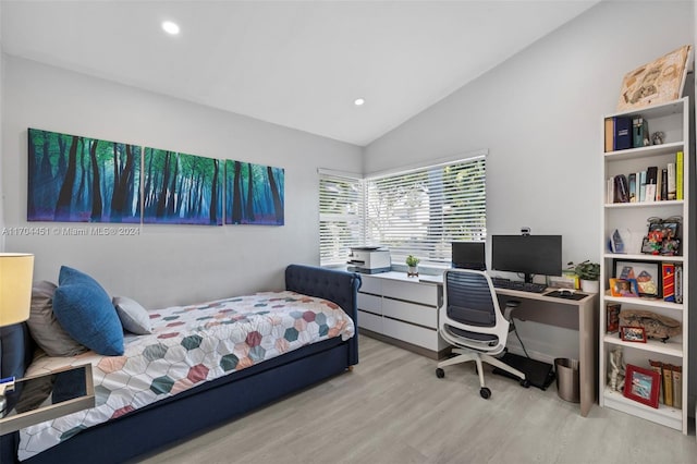 bedroom with light hardwood / wood-style flooring and lofted ceiling