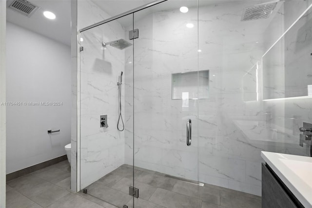 bathroom with vanity, a shower with shower door, and toilet