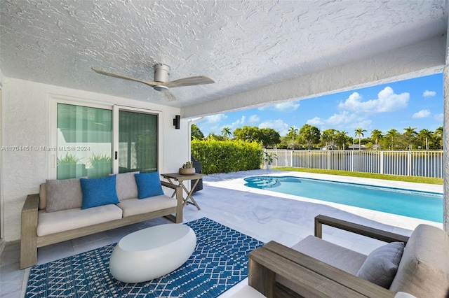 view of pool featuring outdoor lounge area, ceiling fan, and a patio area