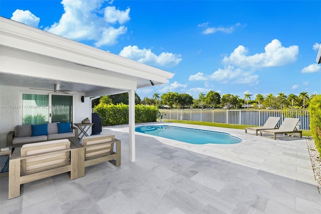 view of pool with an outdoor living space, a water view, ceiling fan, area for grilling, and a patio