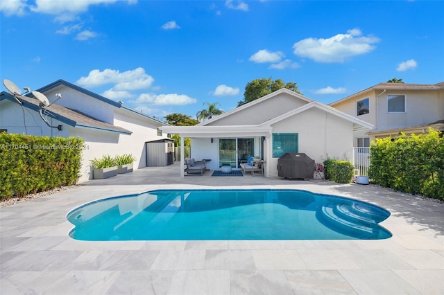 view of swimming pool featuring a grill and a patio area