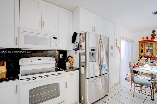 kitchen featuring light tile patterned floors, white appliances, white cabinetry, and backsplash