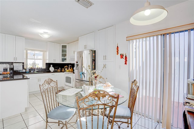 tiled dining room with sink