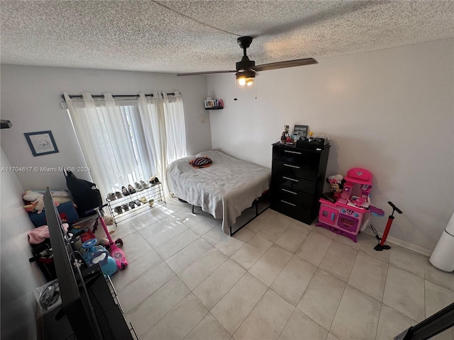 tiled bedroom featuring a textured ceiling and ceiling fan