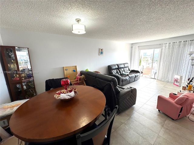 dining area with light tile patterned floors and a textured ceiling