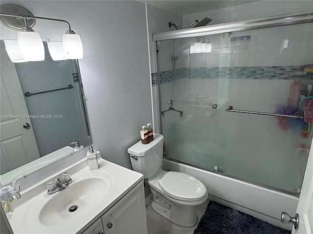 full bathroom featuring tile patterned flooring, vanity, enclosed tub / shower combo, and toilet