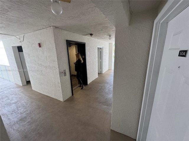 corridor featuring concrete flooring