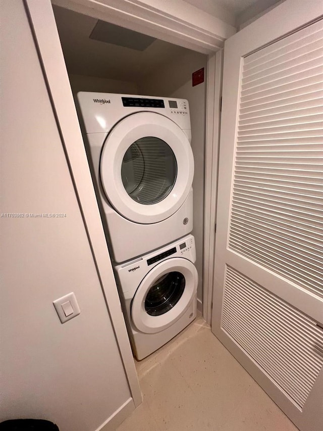 clothes washing area featuring stacked washer and dryer