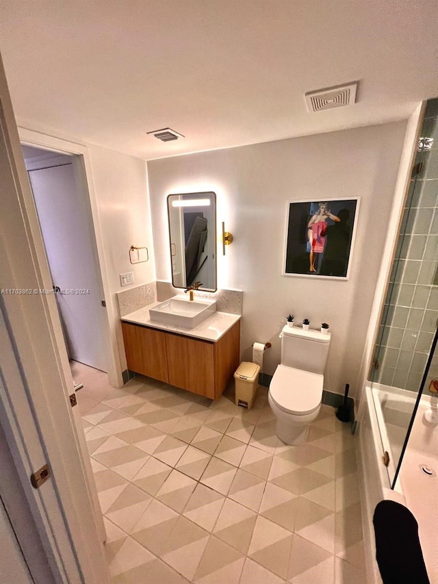 full bathroom with tile patterned floors, shower / washtub combination, vanity, and toilet