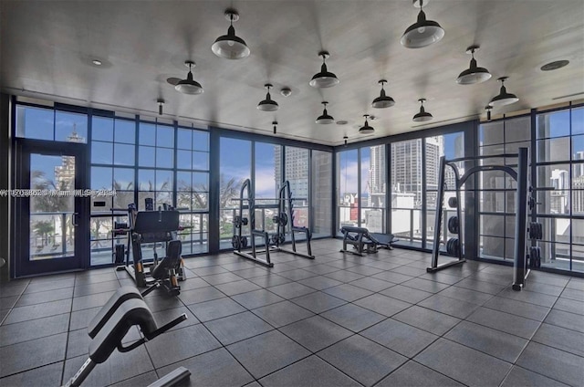 workout area with tile patterned floors and expansive windows