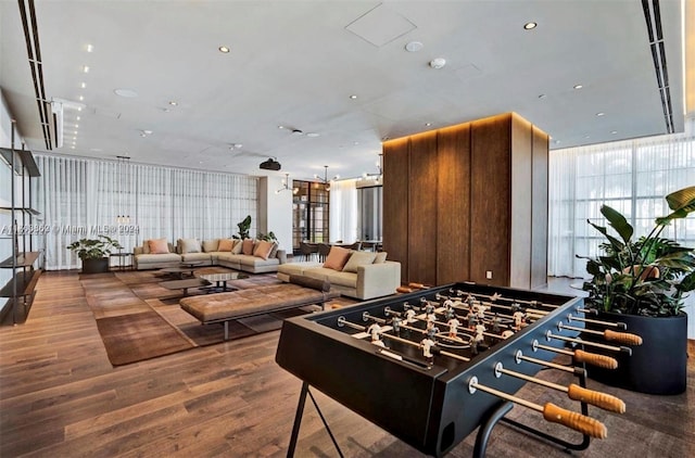 recreation room featuring a wall of windows and hardwood / wood-style flooring