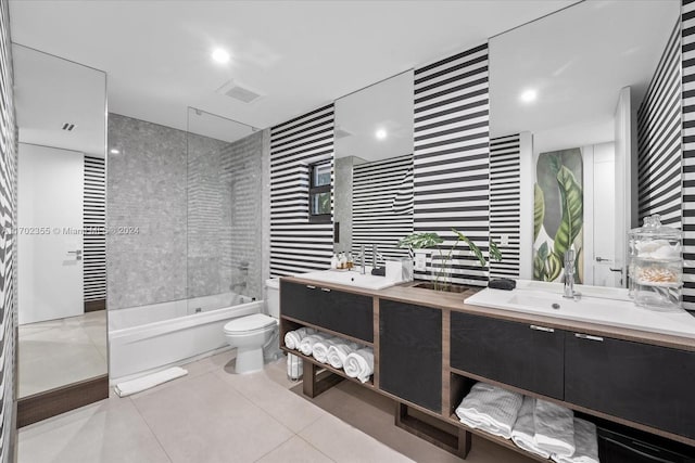 full bathroom featuring tile patterned floors, vanity, toilet, and tiled shower / bath combo