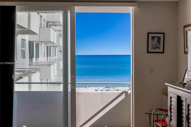 interior space featuring a beach view and a water view