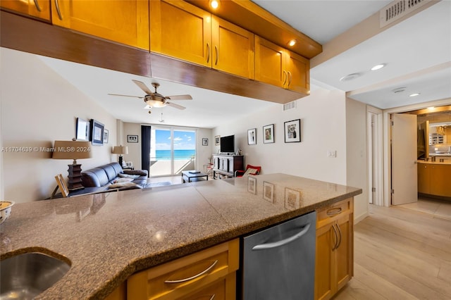 kitchen featuring ceiling fan, sink, stainless steel dishwasher, and light wood-type flooring