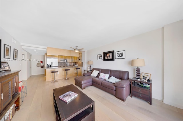 living room featuring ceiling fan and light wood-type flooring