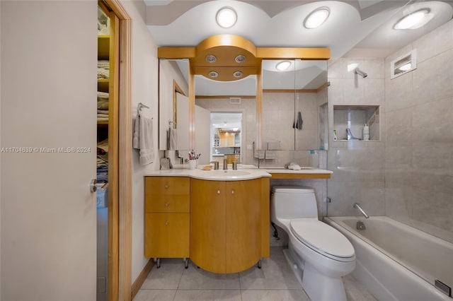 full bathroom with tile patterned floors, vanity, tiled shower / bath combo, and toilet