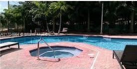 view of swimming pool with a community hot tub