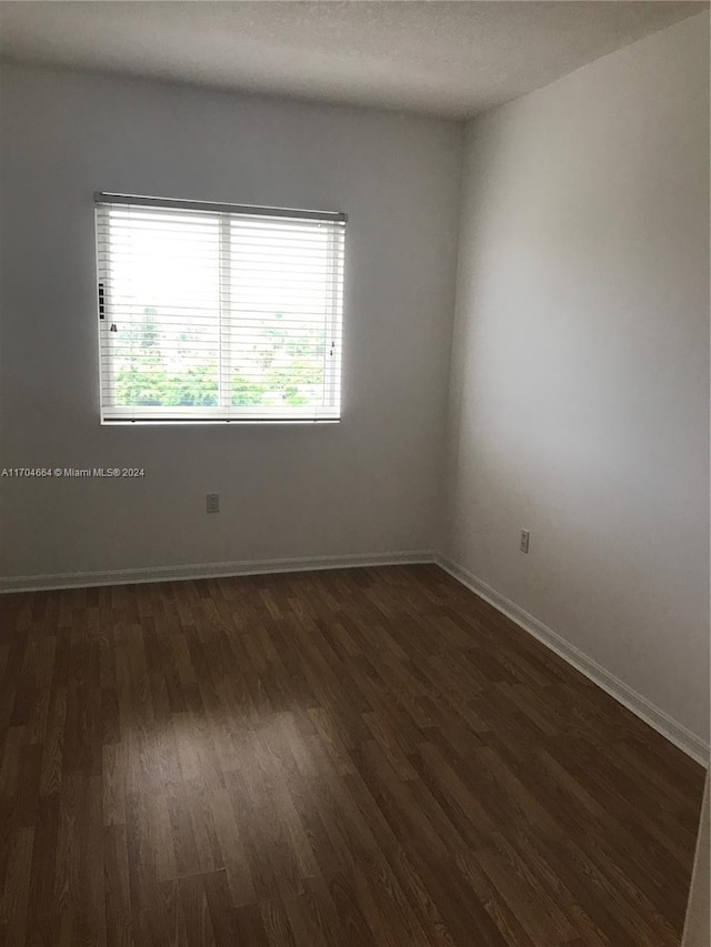 empty room featuring dark hardwood / wood-style floors