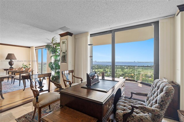 office space featuring floor to ceiling windows, light tile patterned floors, and a textured ceiling