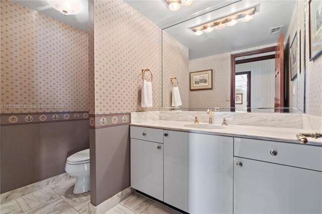 bathroom featuring vanity and toilet