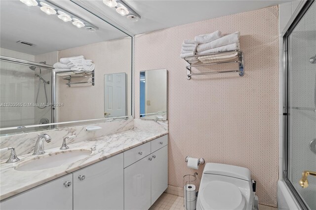 full bathroom featuring vanity, toilet, and enclosed tub / shower combo