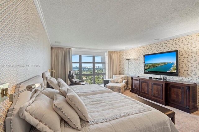 5500 Collins Ave Unit 2302, Miami Beach, FL 33140 - carpeted bedroom with wallpapered walls, ornamental molding, and a textured ceiling
