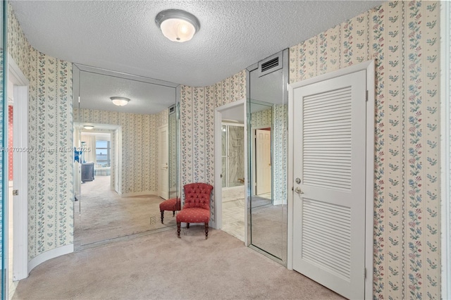 5500 Collins Ave Unit 2302, Miami Beach, FL 33140 - corridor with a textured ceiling, wallpapered walls, and carpet