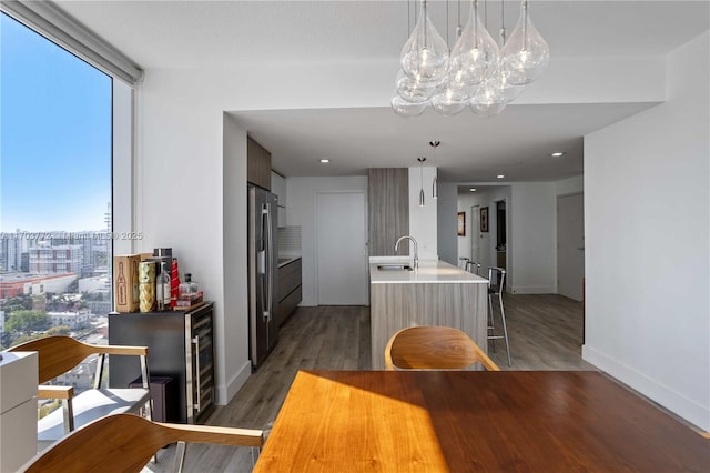 dining area with wine cooler, dark wood-type flooring, and sink