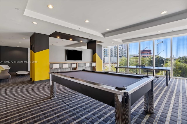 recreation room featuring dark carpet, a raised ceiling, and billiards