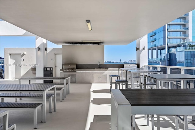 view of patio / terrace featuring an outdoor kitchen, grilling area, and sink