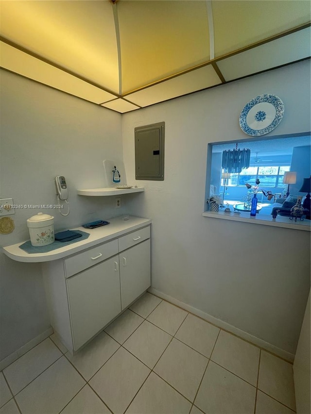 interior space featuring electric panel and light tile patterned flooring