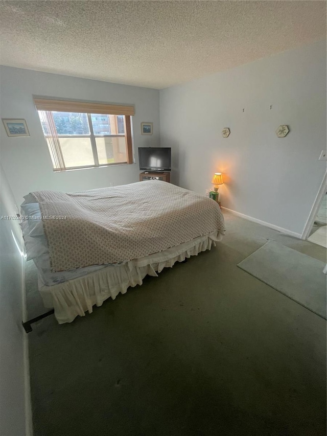 bedroom featuring carpet floors and a textured ceiling