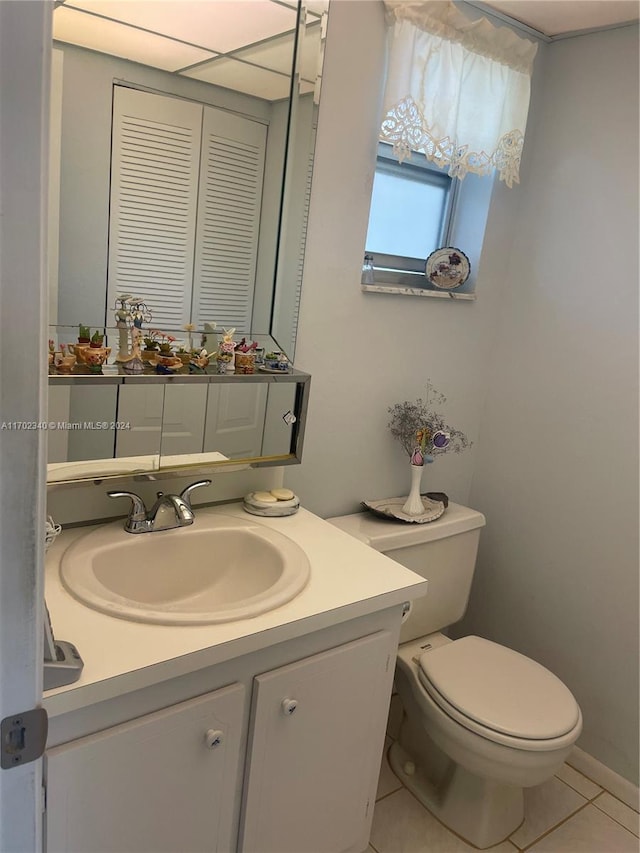 bathroom featuring tile patterned flooring, vanity, and toilet