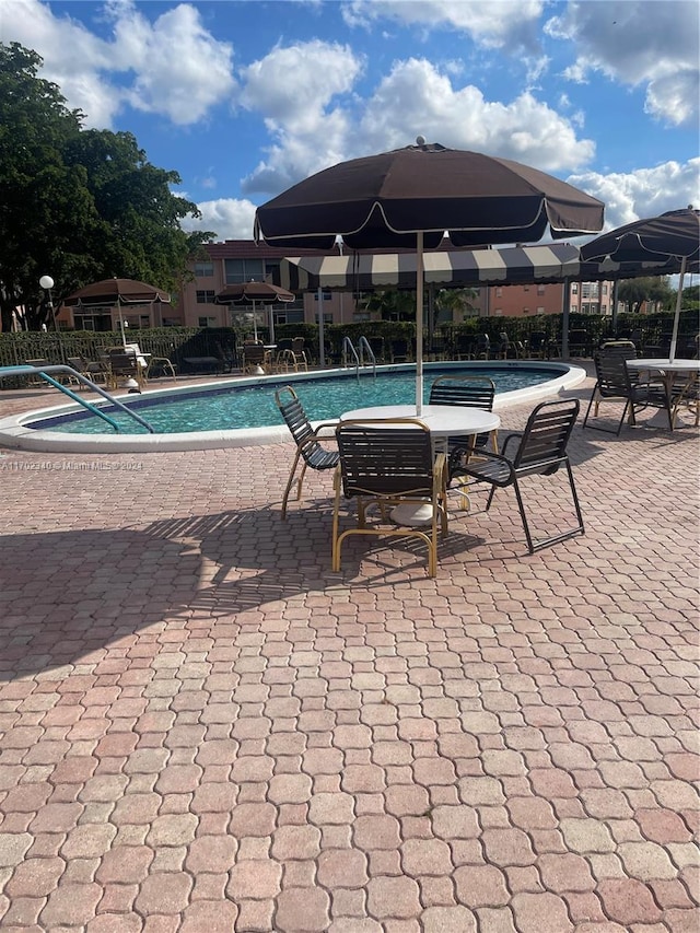 view of swimming pool featuring a patio area