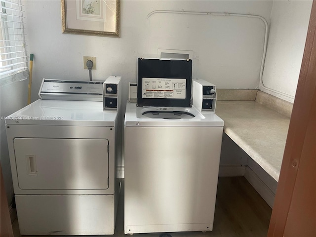 clothes washing area with washing machine and dryer and hardwood / wood-style flooring