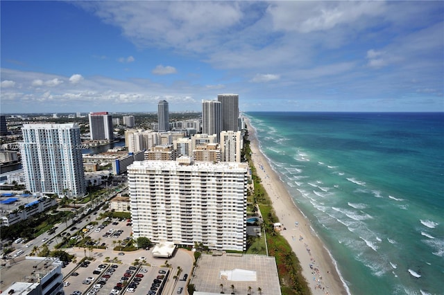 birds eye view of property featuring a water view and a beach view