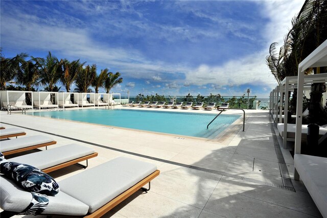 view of swimming pool with a patio