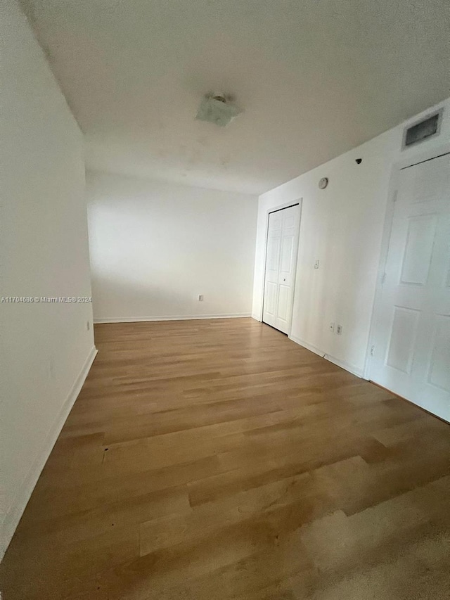 unfurnished room featuring a textured ceiling and hardwood / wood-style flooring