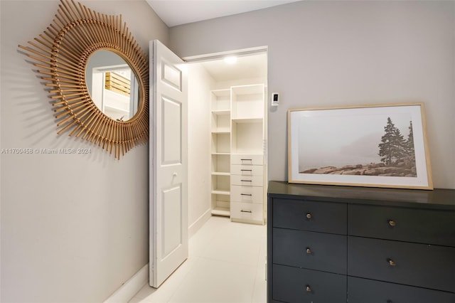 spacious closet with light tile patterned floors