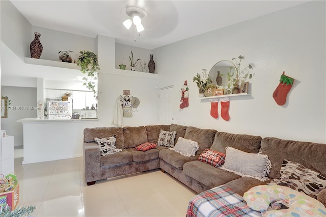 living room with ceiling fan and light tile patterned floors