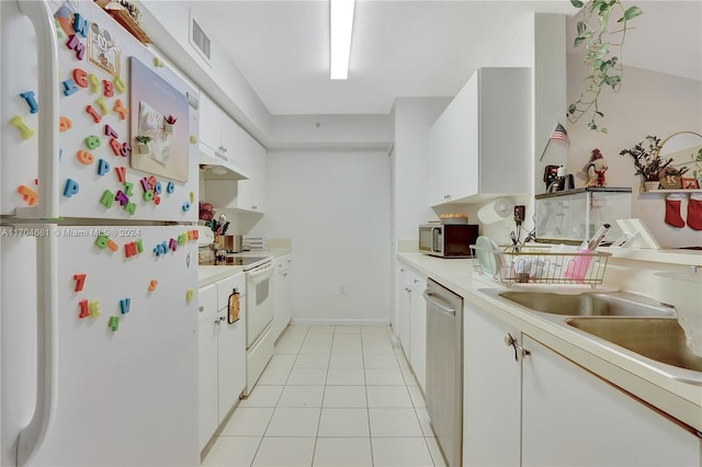 kitchen featuring light tile patterned floors, white cabinetry, sink, and appliances with stainless steel finishes