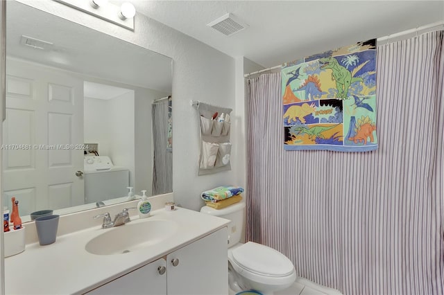 bathroom featuring a shower with shower curtain, vanity, tile patterned flooring, washer / dryer, and toilet